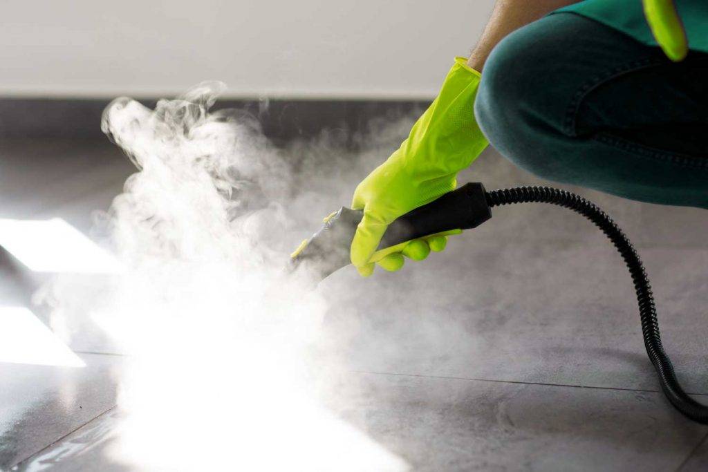 Ein Mitarbeiter von Reinigungskonzepte Dresden reinigt professionell den Teppichboden mit einer modernen Maschine.